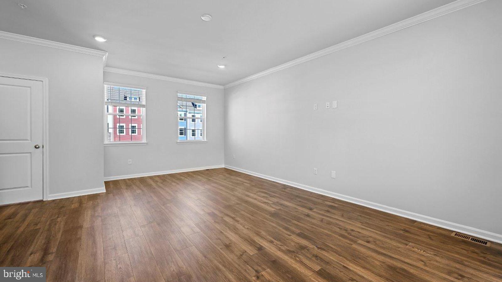 7505 Silver Thread Way Brandywine, MD 20613 - Photo 11 of 24 an empty room with wooden floor and windows