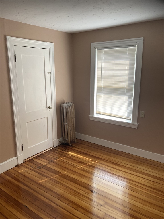 427 North Main Street Randolph, MA 02368 - Photo 18 of 23 a view of an empty room with wooden floor and a window
