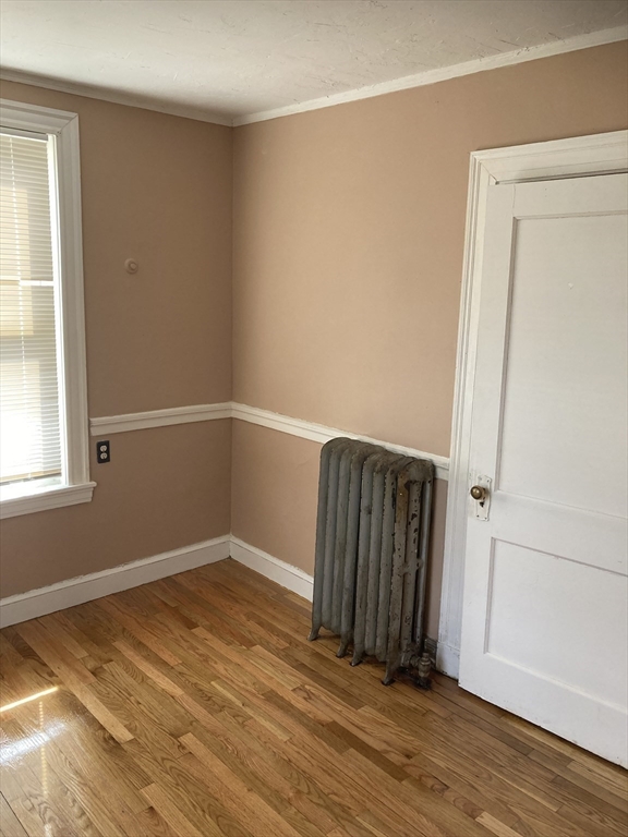 427 North Main Street Randolph, MA 02368 - Photo 19 of 23 an empty room with wooden floor and windows