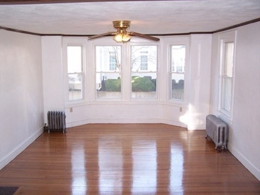 427 North Main Street Randolph, MA 02368 - Photo 5 of 23 a view of an empty room with a window and wooden floor