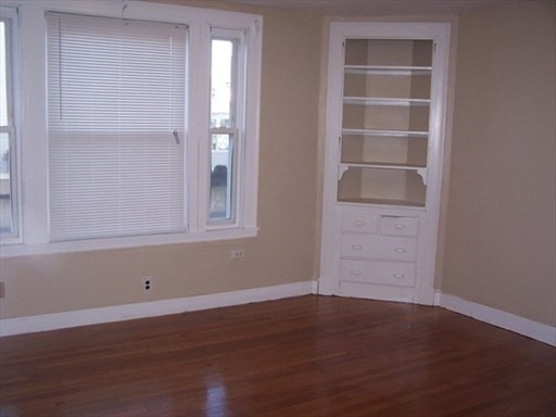 427 North Main Street Randolph, MA 02368 - Photo 7 of 23 a view of empty room with wooden floor and fan