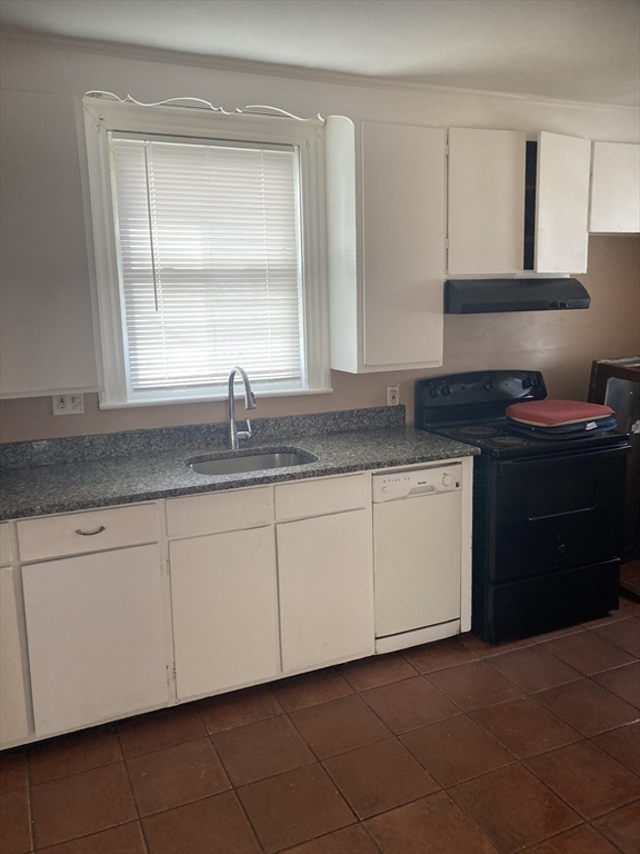 427 North Main Street Randolph, MA 02368 - Photo 10 of 23 a kitchen with granite countertop white cabinets sink and window