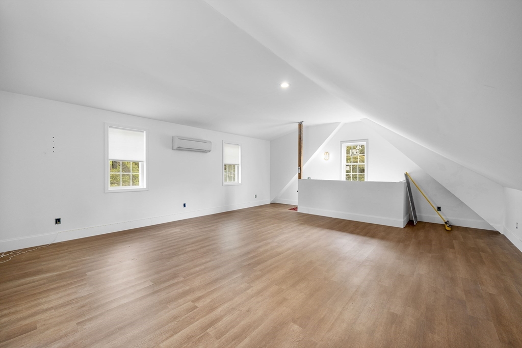 46 Wing Lane Acushnet, MA 02743 - Photo 27 of 38 a view of an empty room with wooden floor and a window