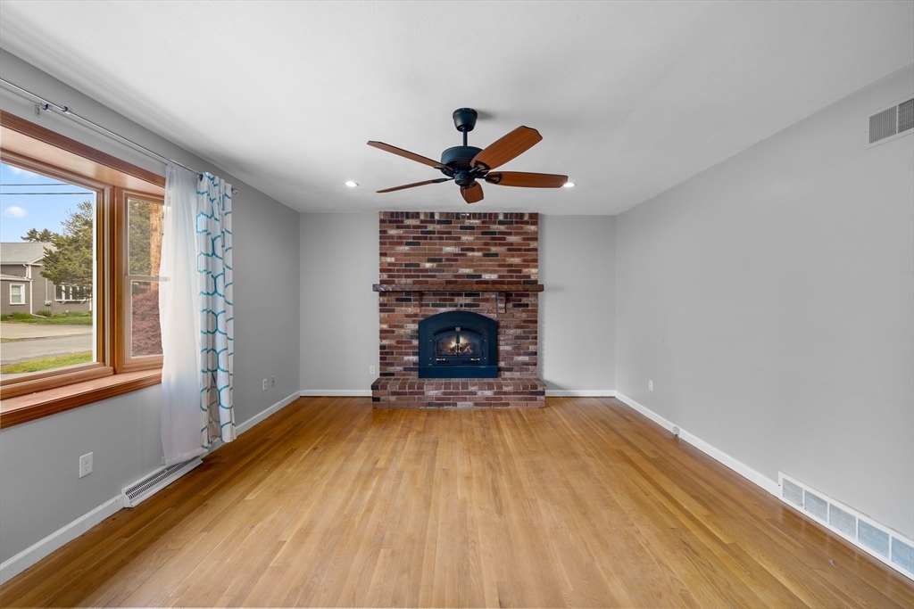 46 Wing Lane Acushnet, MA 02743 - Photo 7 of 38 wooden floor fireplace and window in an empty room