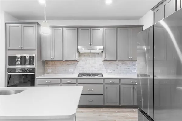 a kitchen with stainless steel appliances granite countertop a refrigerator sink and cabinets