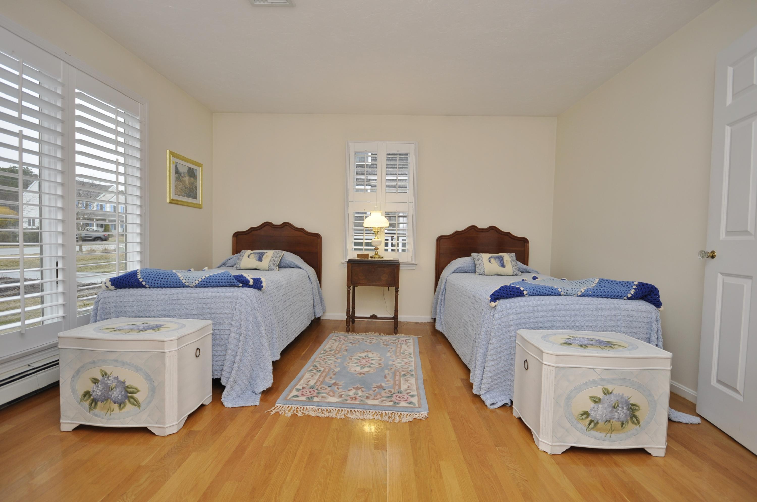 4 Oakbluff Road Sagamore Beach, MA 02562 - Photo 16 of 35 a bedroom with two beds and a window