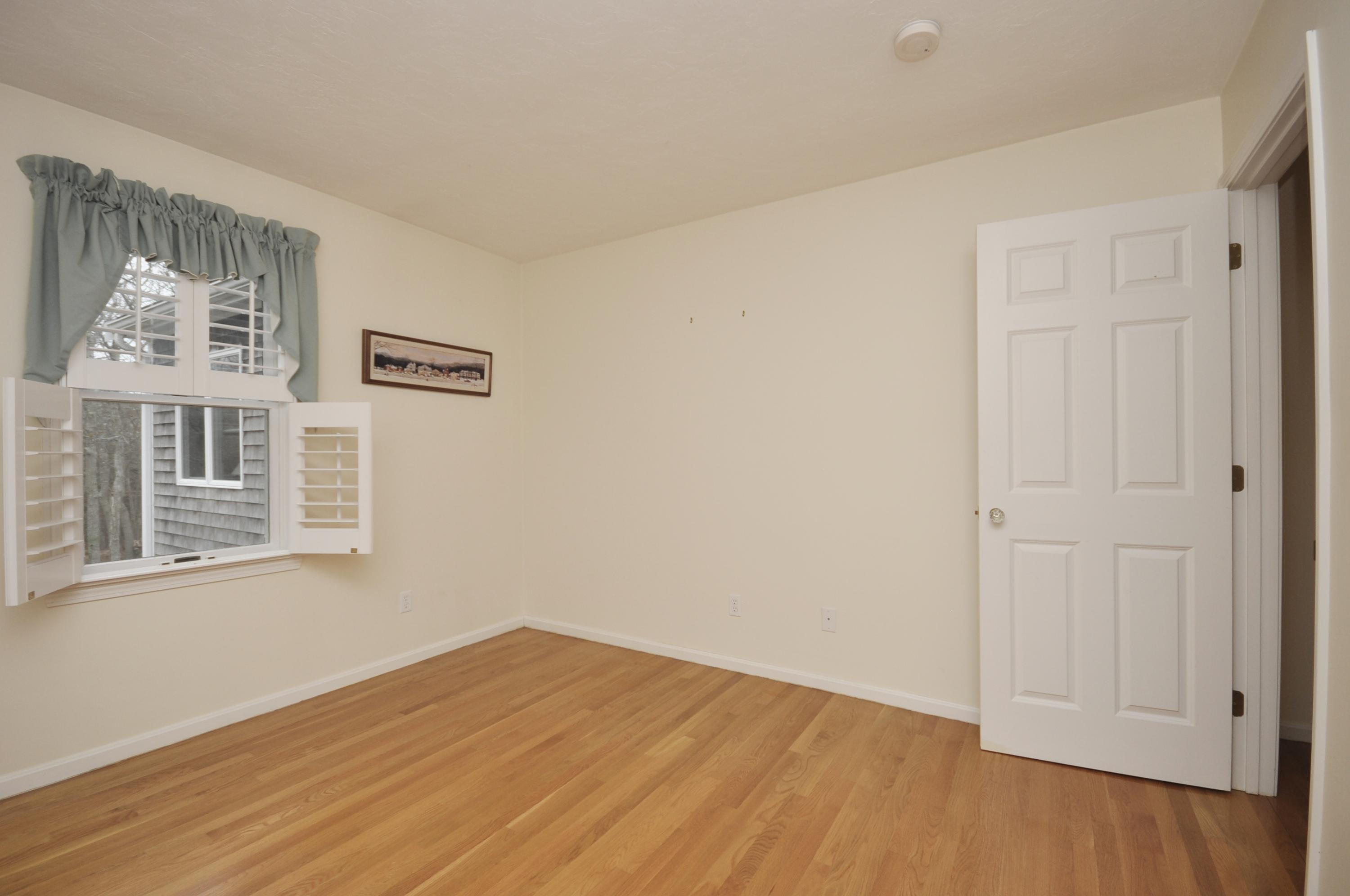 4 Oakbluff Road Sagamore Beach, MA 02562 - Photo 18 of 35 a view of an empty room with wooden floor and a window