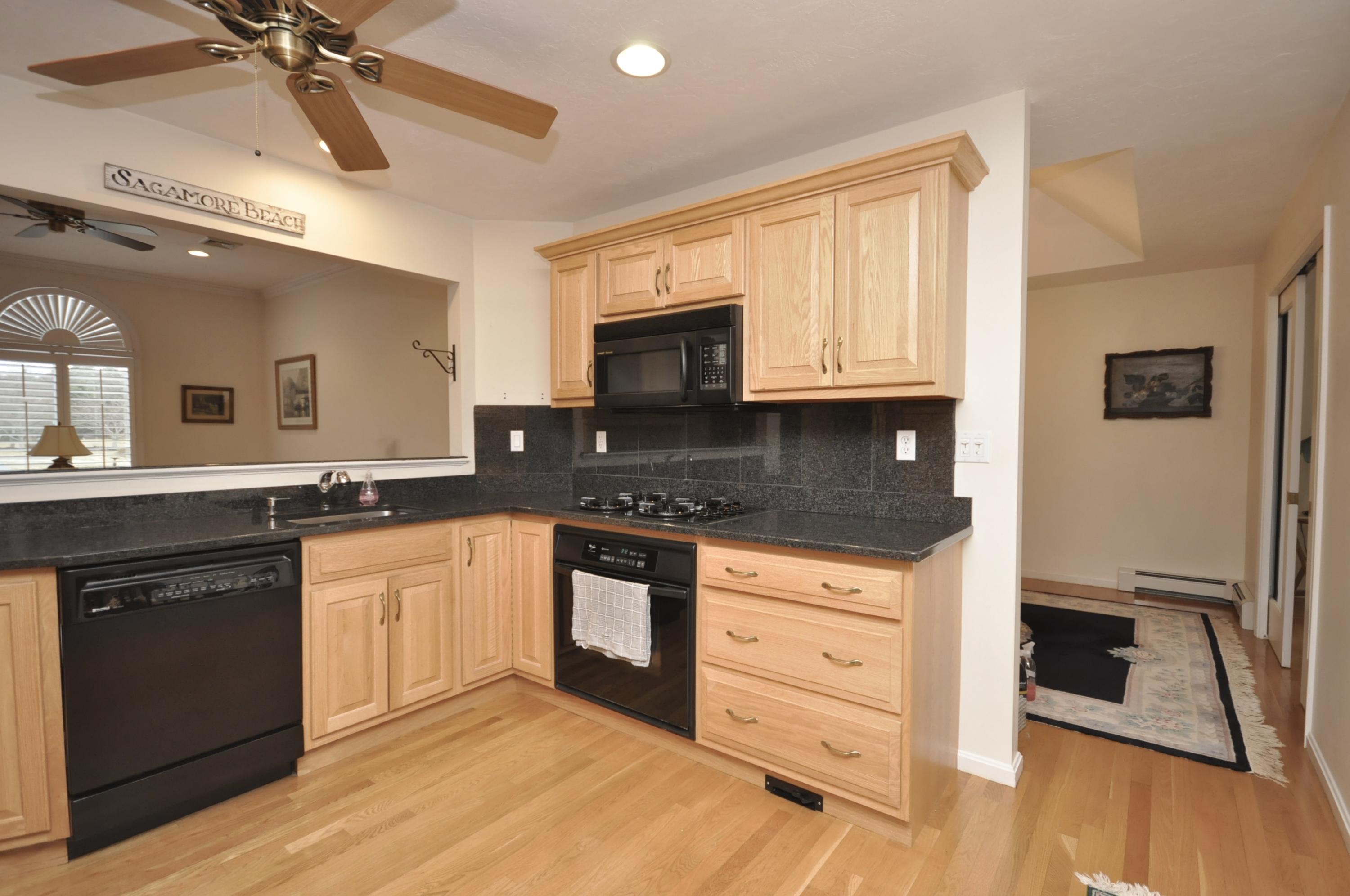 4 Oakbluff Road Sagamore Beach, MA 02562 - Photo 4 of 35 a kitchen with granite countertop a stove a sink and a microwave