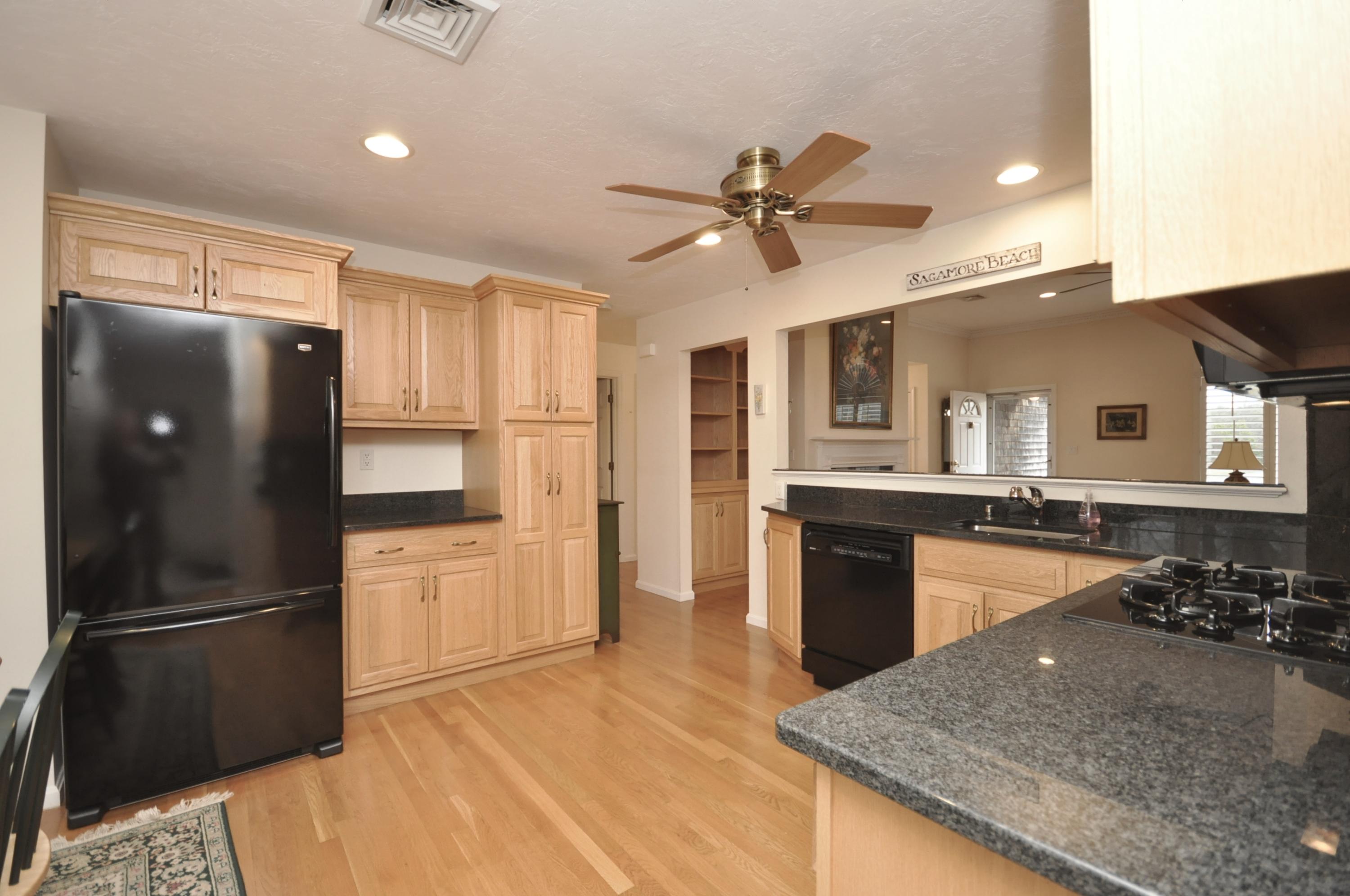 4 Oakbluff Road Sagamore Beach, MA 02562 - Photo 6 of 35 a kitchen with stainless steel appliances granite countertop a refrigerator a stove and a sink