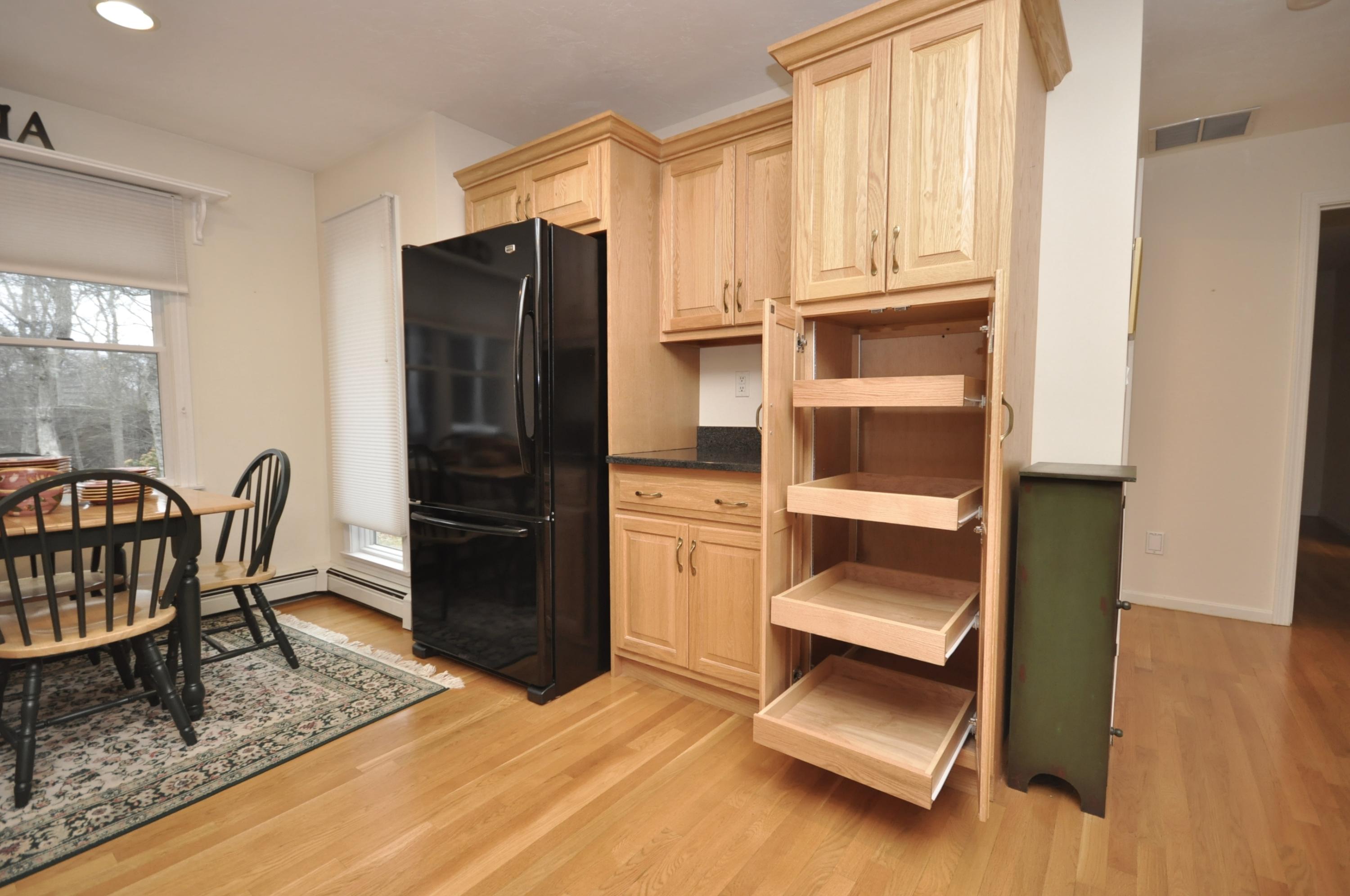 4 Oakbluff Road Sagamore Beach, MA 02562 - Photo 7 of 35 a kitchen with a refrigerator and chair