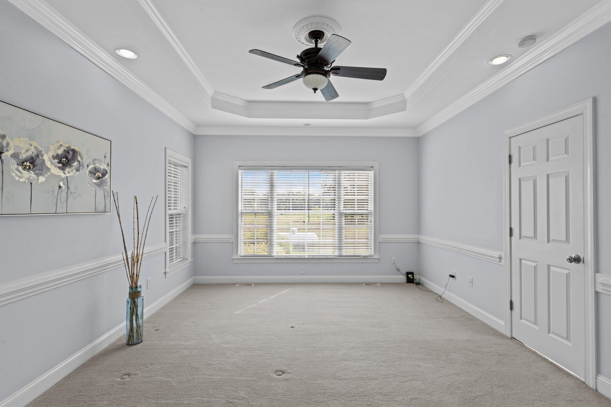 525 Eatmon Road Zebulon, NC 27597 - Photo 10 of 30 Primary Bedroom with tray ceiling, triple window, and ceiling fan. Primary Bedroom