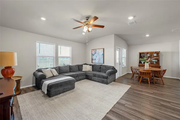 a living room with furniture a bed and a window