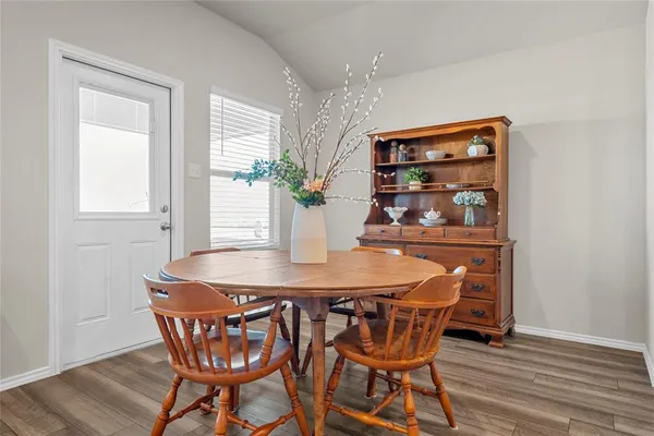 a dining room with furniture and wooden floor