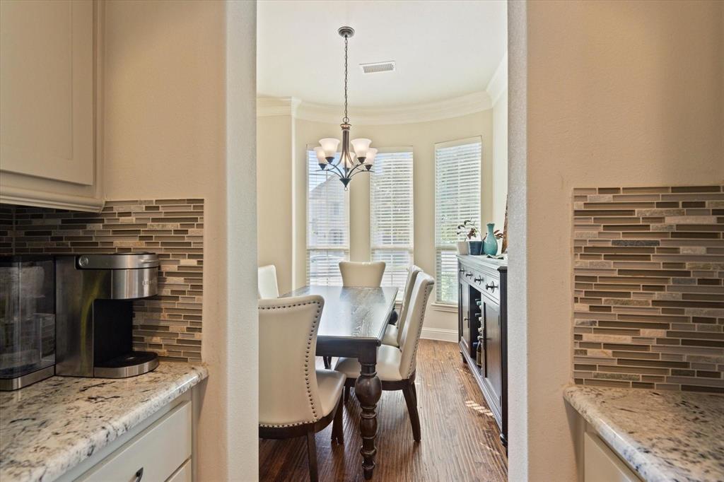 3615 Adriana Avenue Irving, TX 75038 - Photo 14 of 33 a view of kitchen island dining table and chairs