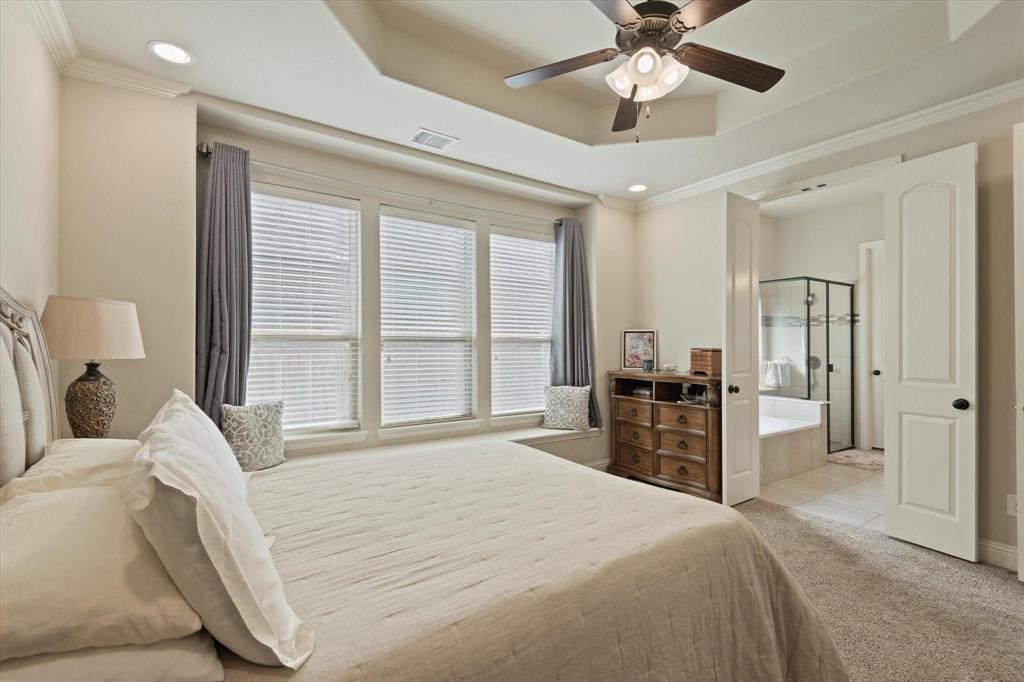 3615 Adriana Avenue Irving, TX 75038 - Photo 18 of 33 a bedroom with a large bed and a chandelier fan