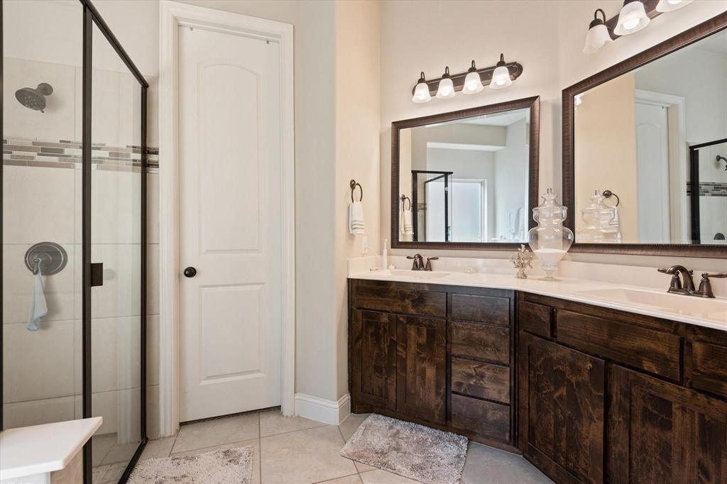 3615 Adriana Avenue Irving, TX 75038 - Photo 19 of 33 a bathroom with a double vanity sink and mirror