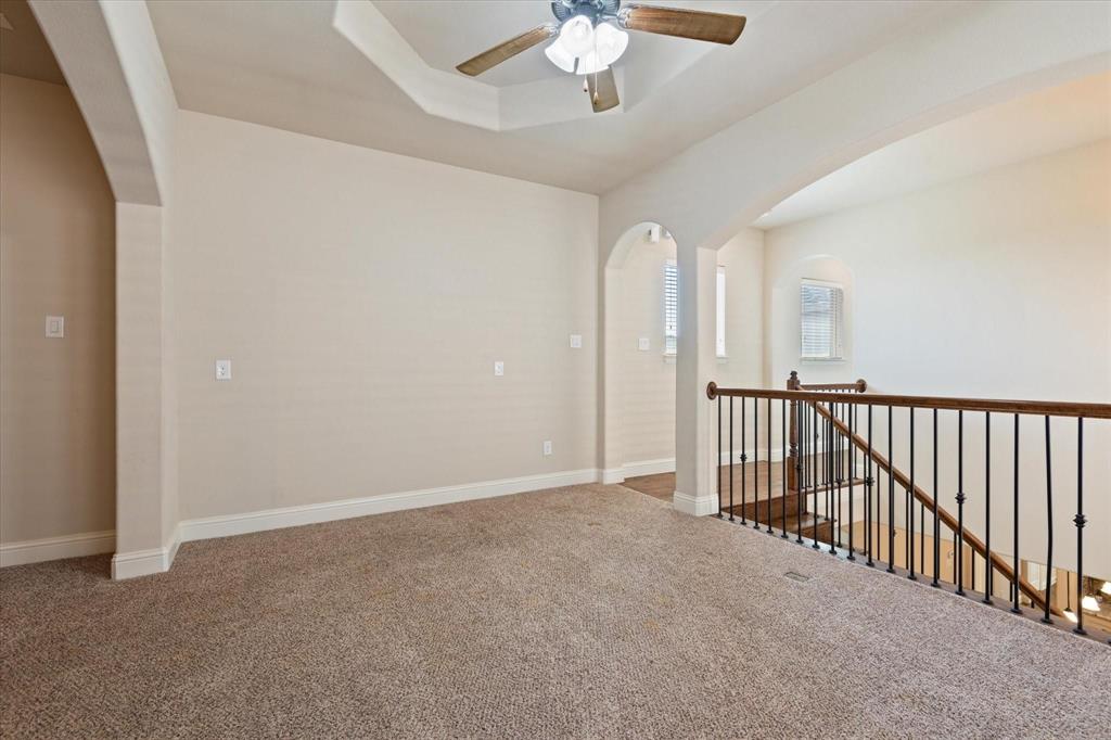 3615 Adriana Avenue Irving, TX 75038 - Photo 24 of 33 en empty room with windows and ceiling fan