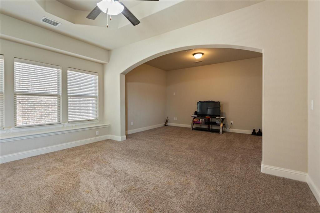 3615 Adriana Avenue Irving, TX 75038 - Photo 26 of 33 an empty room with a ceiling fan and window