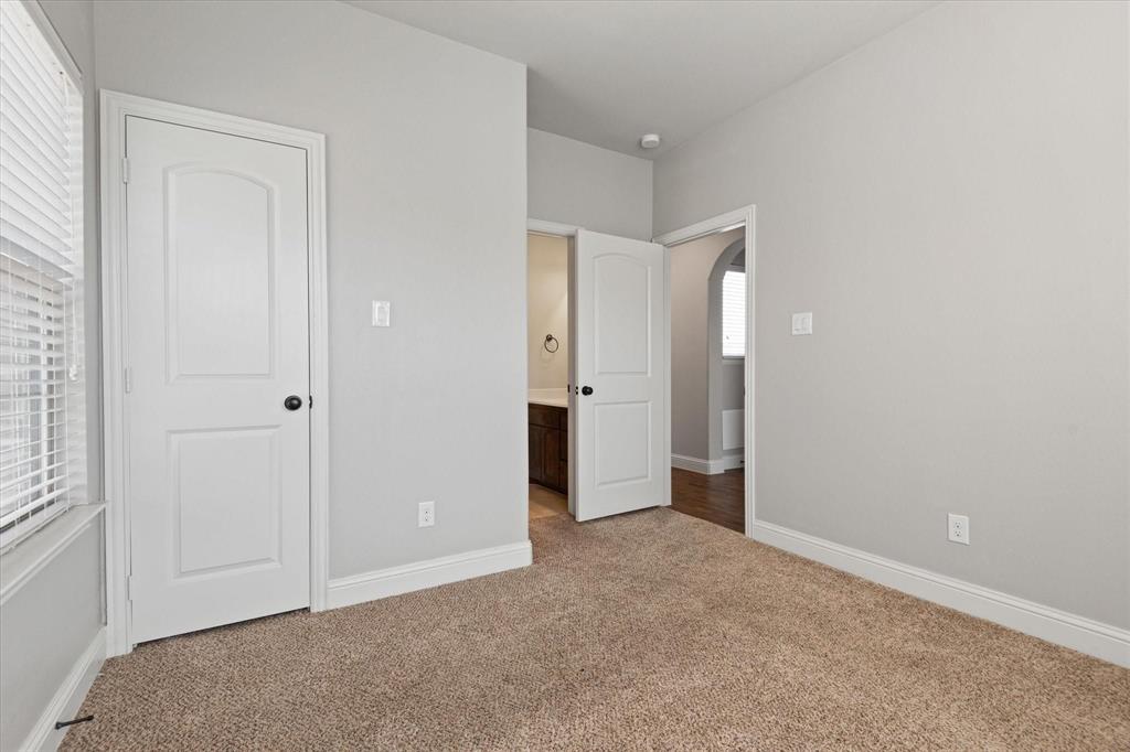 3615 Adriana Avenue Irving, TX 75038 - Photo 28 of 33 an empty room with closet and wooden floor