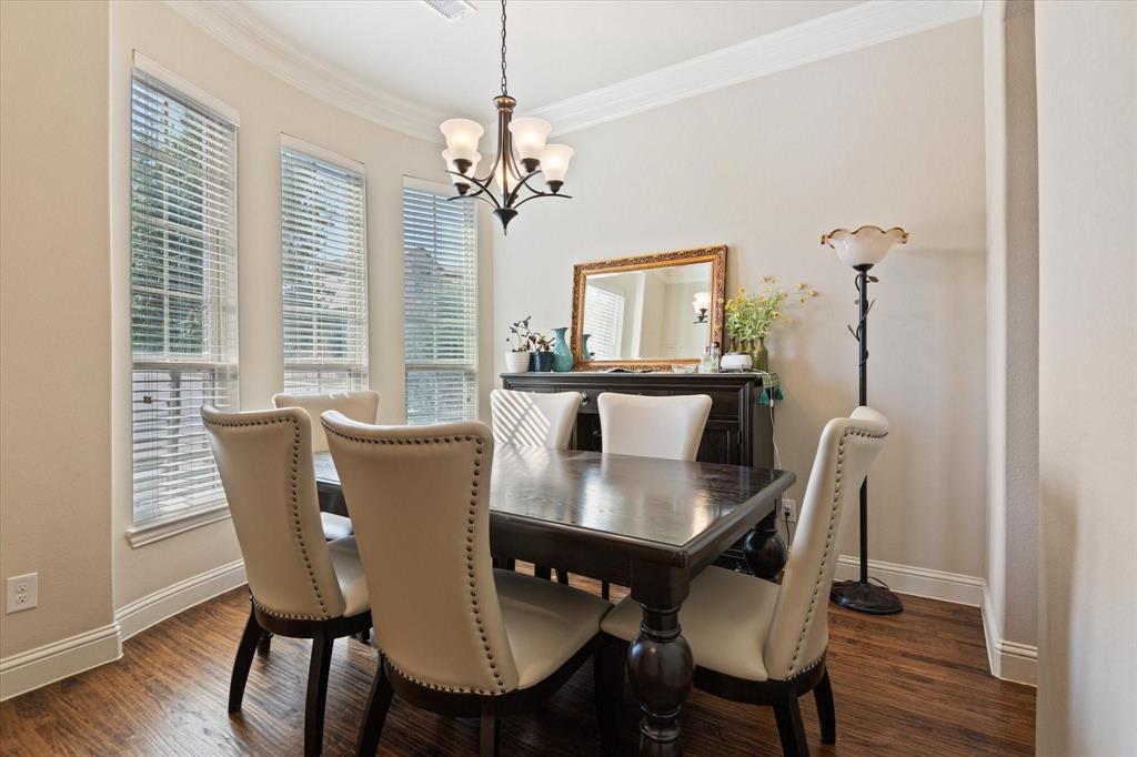 3615 Adriana Avenue Irving, TX 75038 - Photo 3 of 33 a dining room with furniture a chandelier and wooden floor