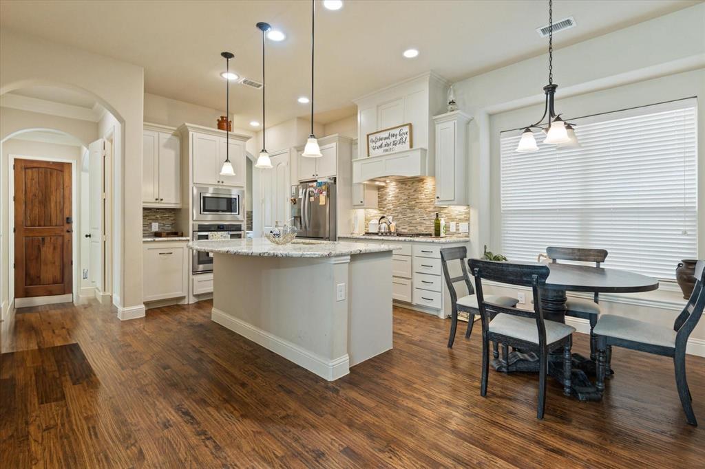 3615 Adriana Avenue Irving, TX 75038 - Photo 8 of 33 a large kitchen with a table and chairs