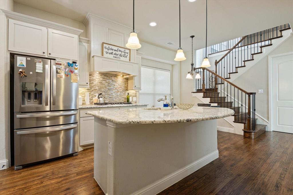 3615 Adriana Avenue Irving, TX 75038 - Photo 10 of 33 a view of a kitchen with stainless steel appliances granite countertop a refrigerator a oven a dining table and chairs with wooden floor