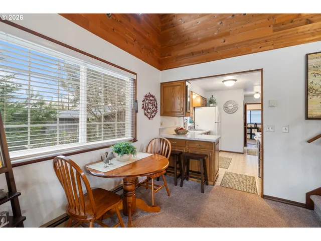a view of a dining room with furniture window and outside view