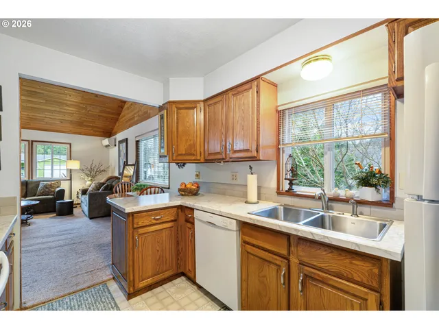 a kitchen with a sink window and cabinets