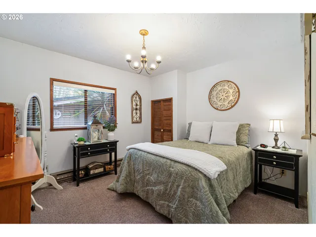 a bedroom with a bed and a table in it