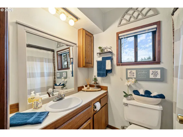 a bathroom with a sink a vanity and a mirror