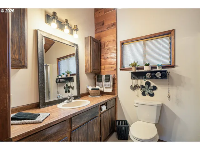 a bathroom with a sink vanity mirror and toilet