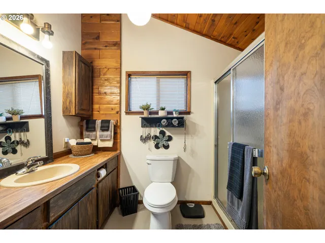 a bathroom with a granite countertop toilet sink and mirror