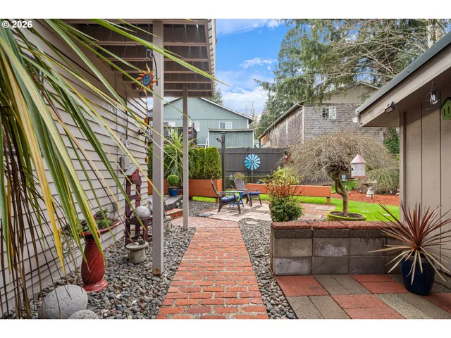a view of a patio with couches and table and chairs with wooden floor and plants