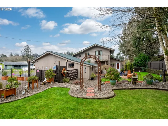 a front view of a house with a garden and outdoor seating