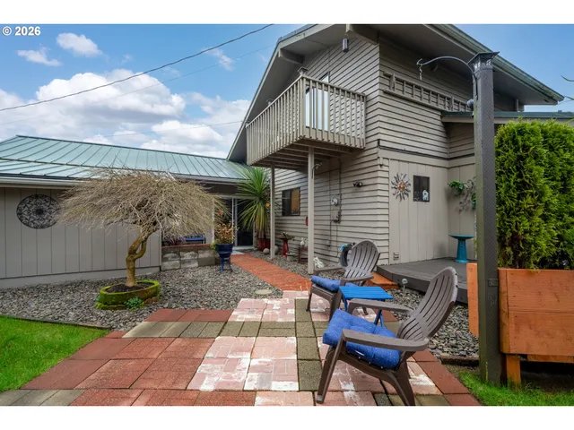 a view of a patio with table and chairs with wooden fence