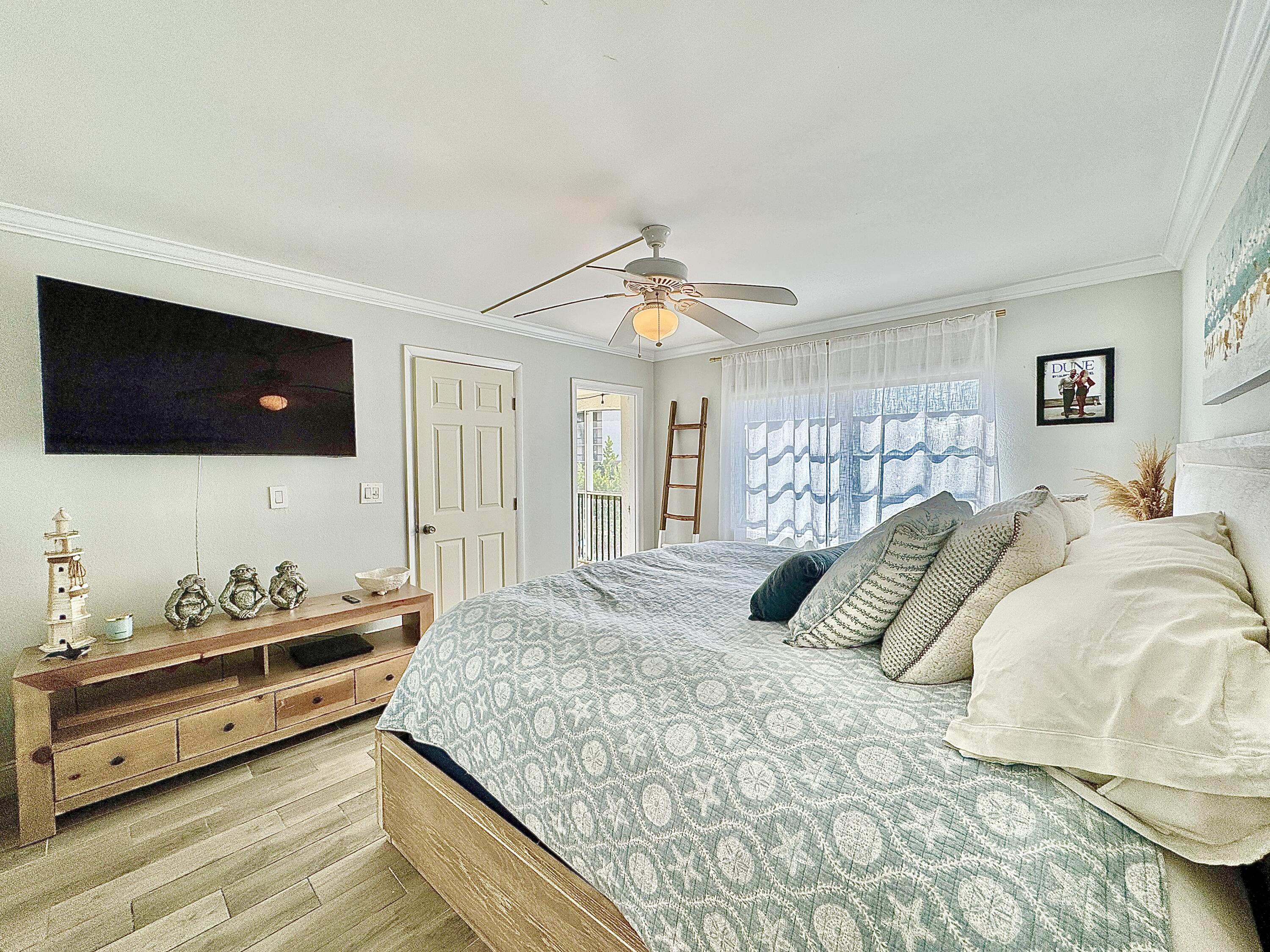 2871 North Ocean Boulevard, Unit R248 Boca Raton, FL 33431 - Photo 11 of 44 a bedroom with a bed and a flat screen tv