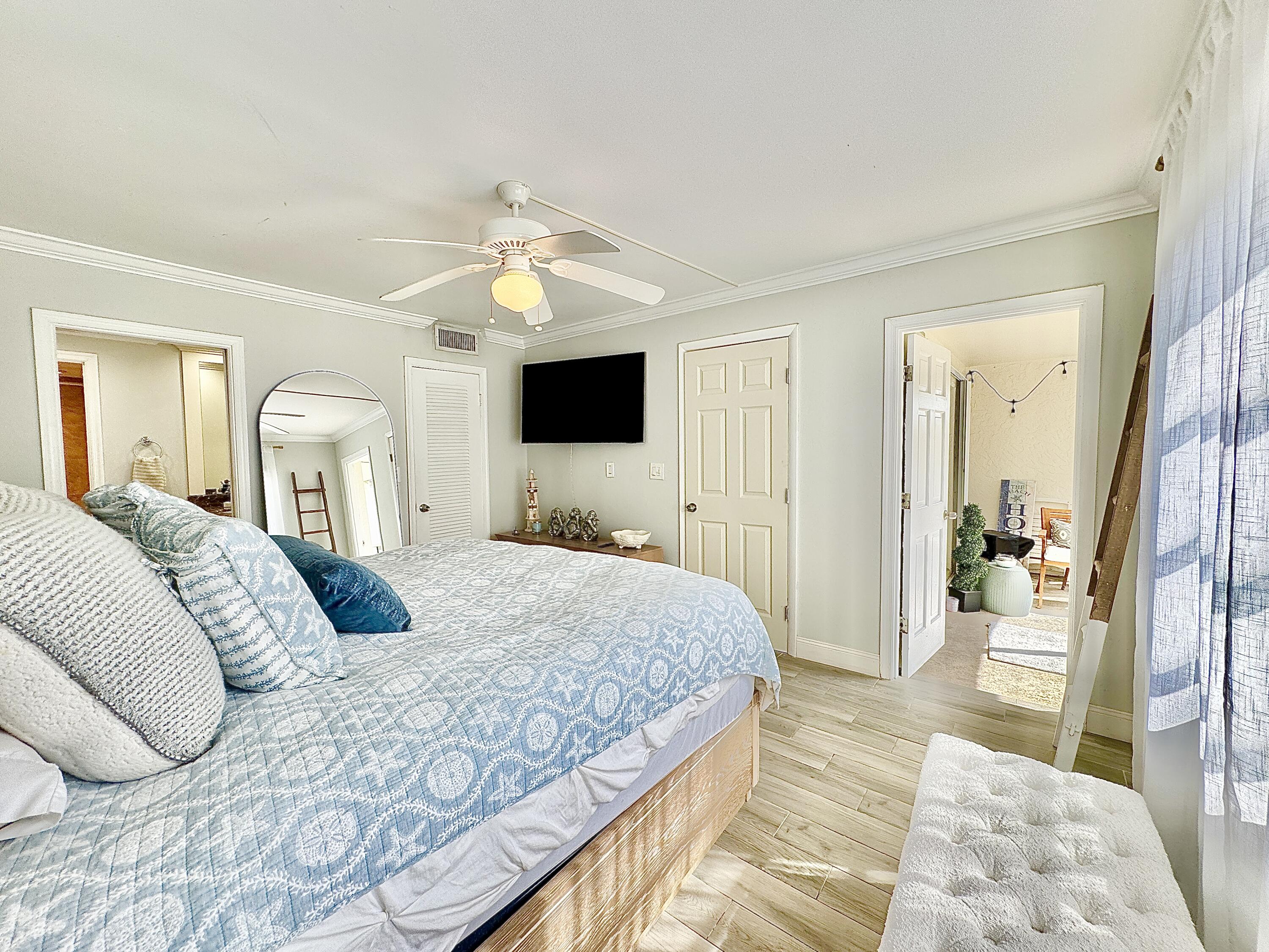 2871 North Ocean Boulevard, Unit R248 Boca Raton, FL 33431 - Photo 12 of 44 a bedroom with a large bed and a television