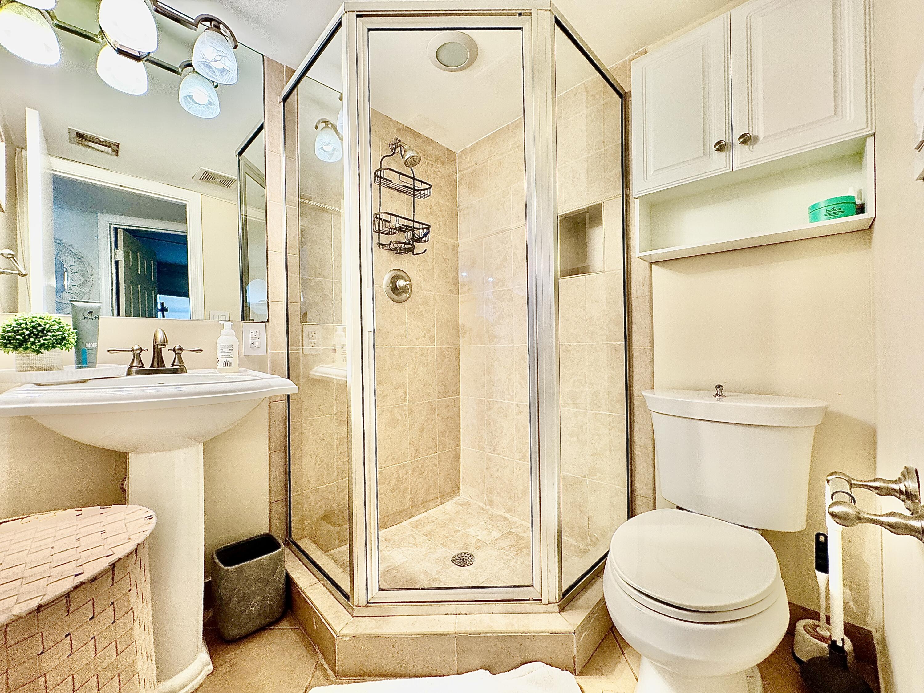 2871 North Ocean Boulevard, Unit R248 Boca Raton, FL 33431 - Photo 16 of 44 a bathroom with a sink a toilet and shower