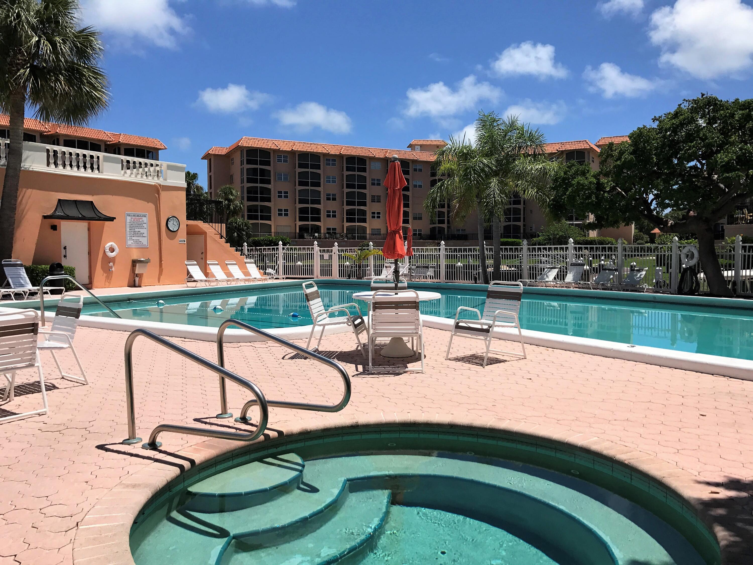 2871 North Ocean Boulevard, Unit R248 Boca Raton, FL 33431 - Photo 21 of 44 a view of a swimming pool with a patio and a garden
