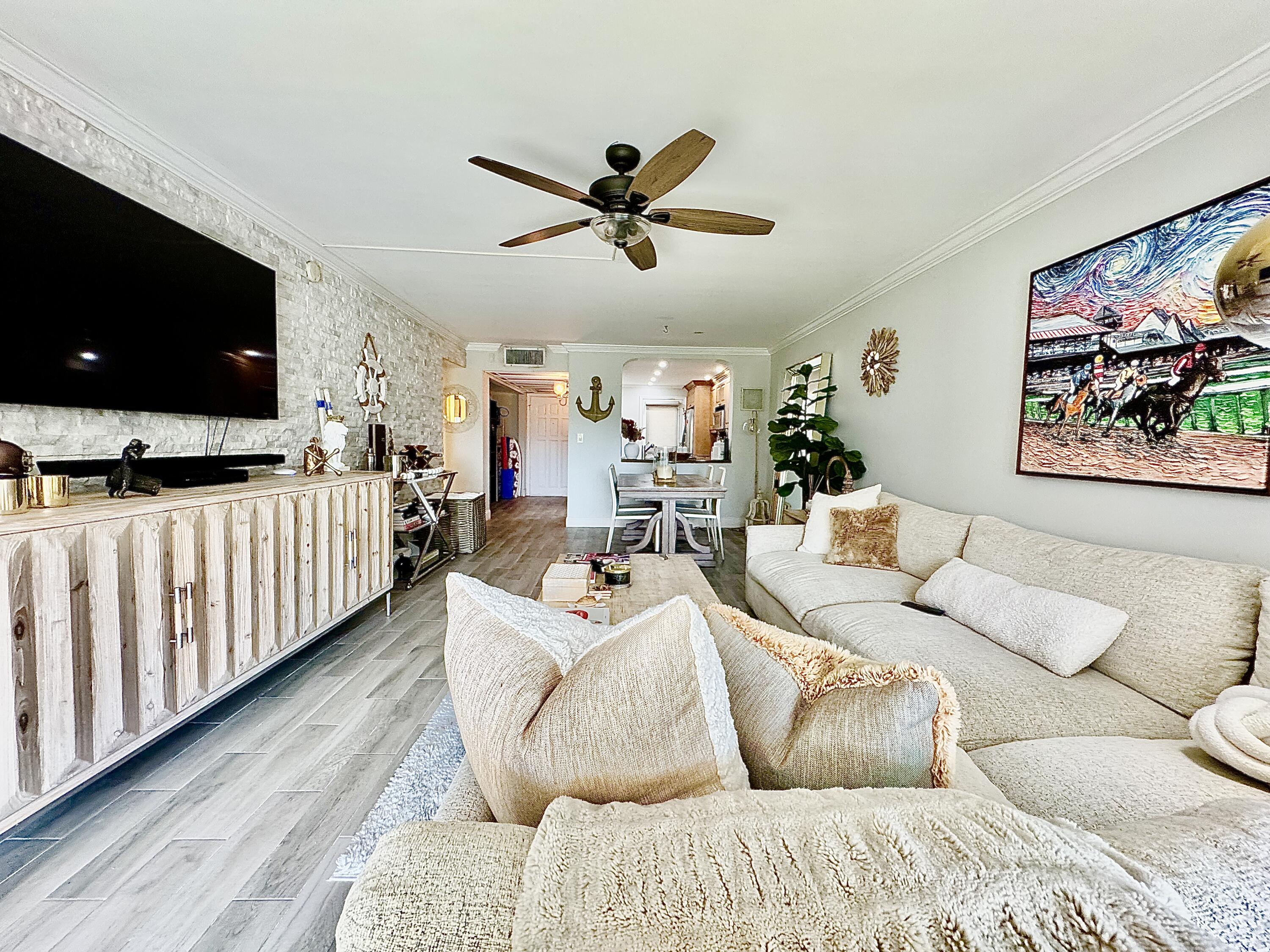 2871 North Ocean Boulevard, Unit R248 Boca Raton, FL 33431 - Photo 4 of 44 a living room with furniture and a flat screen tv