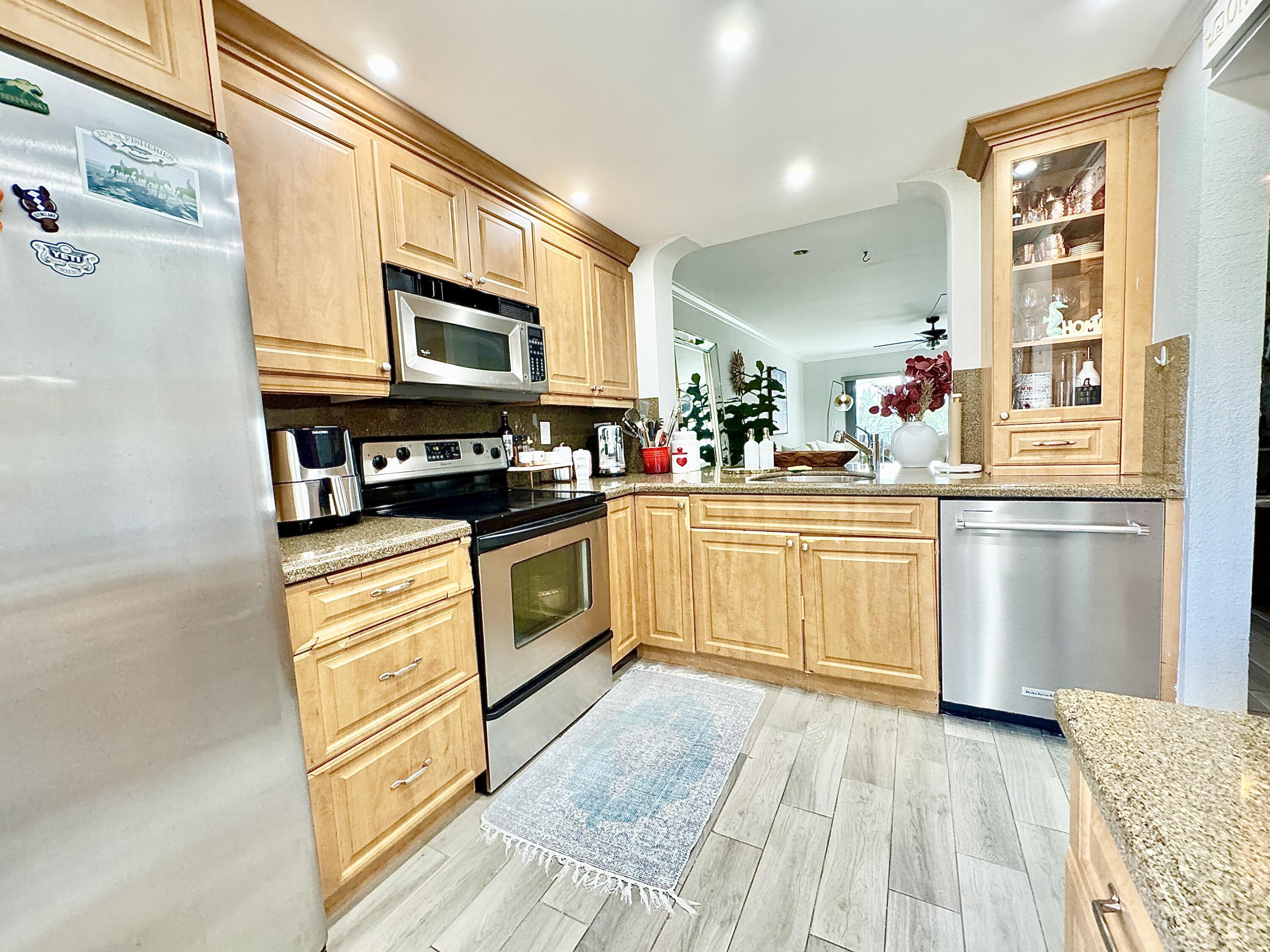 2871 North Ocean Boulevard, Unit R248 Boca Raton, FL 33431 - Photo 7 of 44 a kitchen with stainless steel appliances a stove top oven