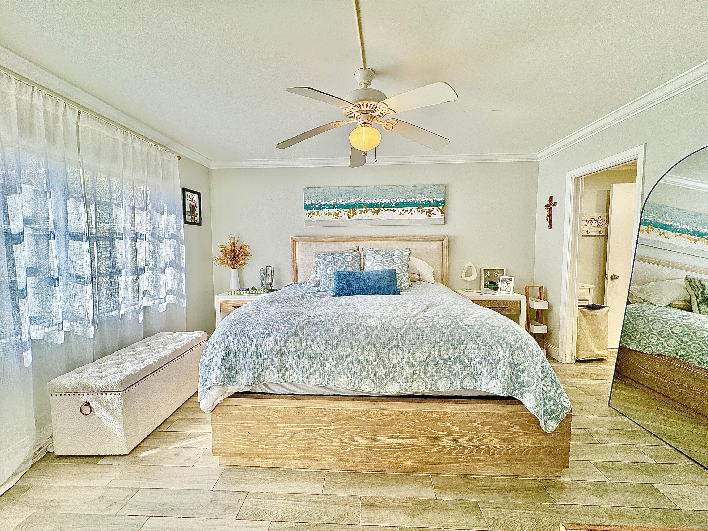 2871 North Ocean Boulevard, Unit R248 Boca Raton, FL 33431 - Photo 10 of 44 a bedroom with a large bed and a chandelier