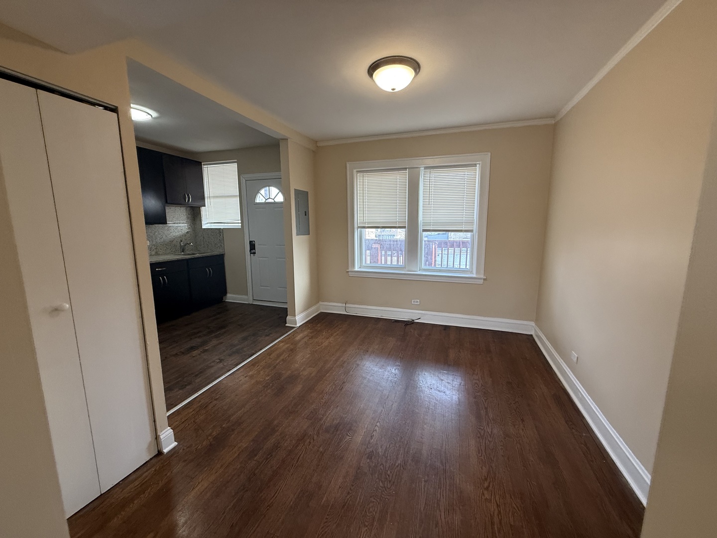 2805 North Kilbourn Avenue, Unit 3S Chicago, IL 60639 - Photo 4 of 13 an empty room with wooden floor and windows