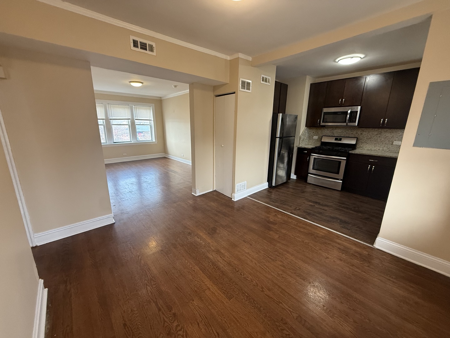 2805 North Kilbourn Avenue, Unit 3S Chicago, IL 60639 - Photo 5 of 13 a kitchen with granite countertop a refrigerator and wooden floor
