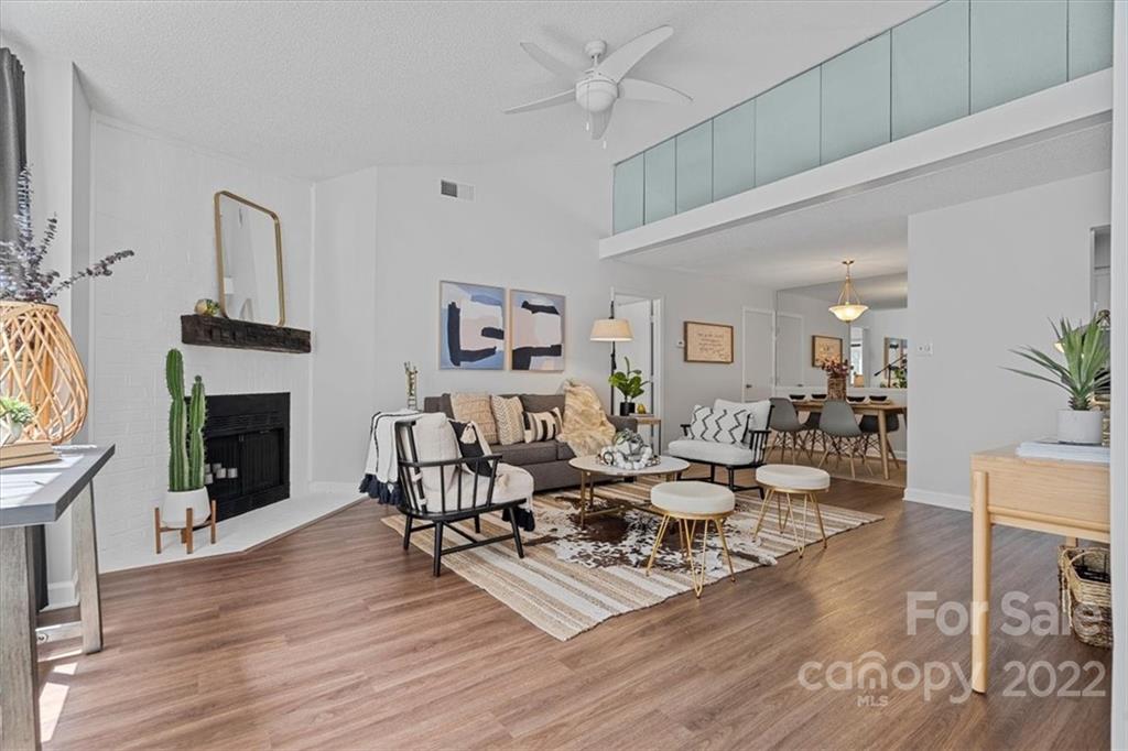 a living room with fireplace furniture and a wooden floor