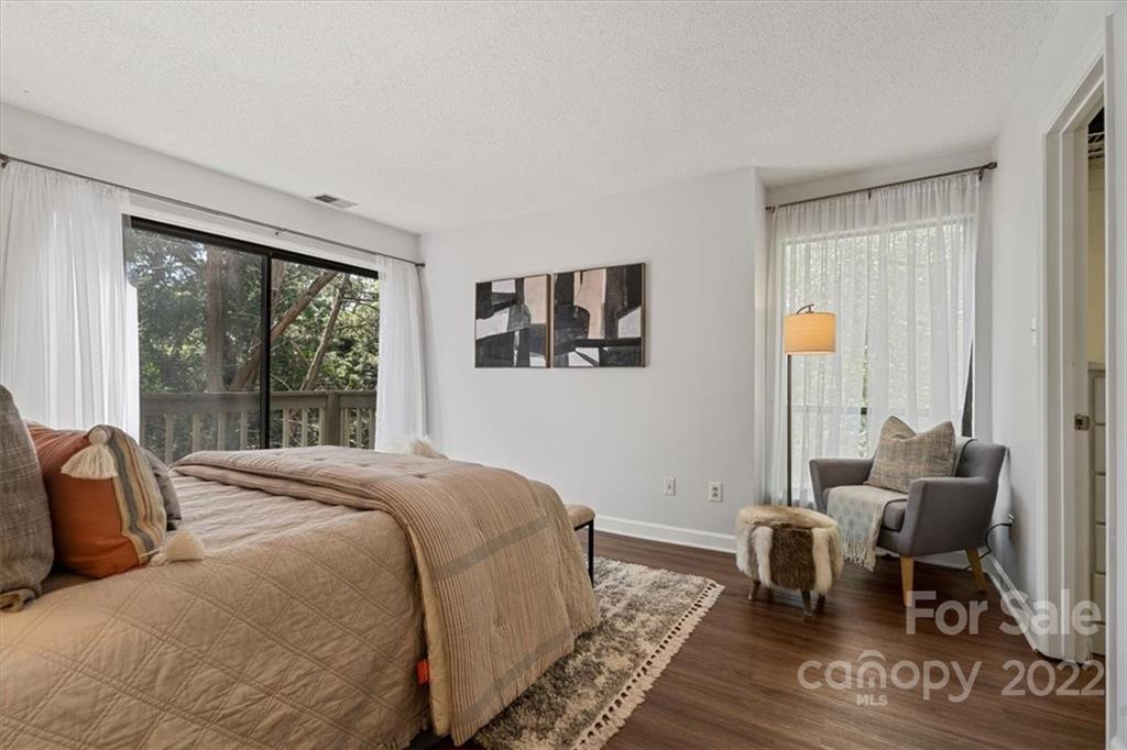 1606 Sharon Road West Charlotte, NC 28210 - Photo 11 of 19 a bedroom with a bed a table and chair
