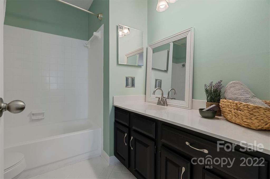 1606 Sharon Road West Charlotte, NC 28210 - Photo 13 of 19 a bathroom with a sink and a mirror