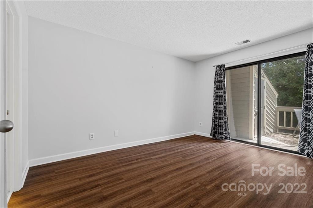 1606 Sharon Road West Charlotte, NC 28210 - Photo 14 of 19 wooden floor in an empty room with a window