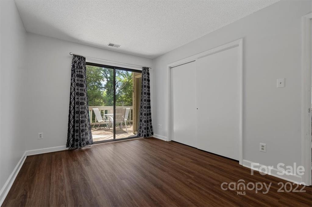 1606 Sharon Road West Charlotte, NC 28210 - Photo 15 of 19 a view of an empty room with wooden floor and a window