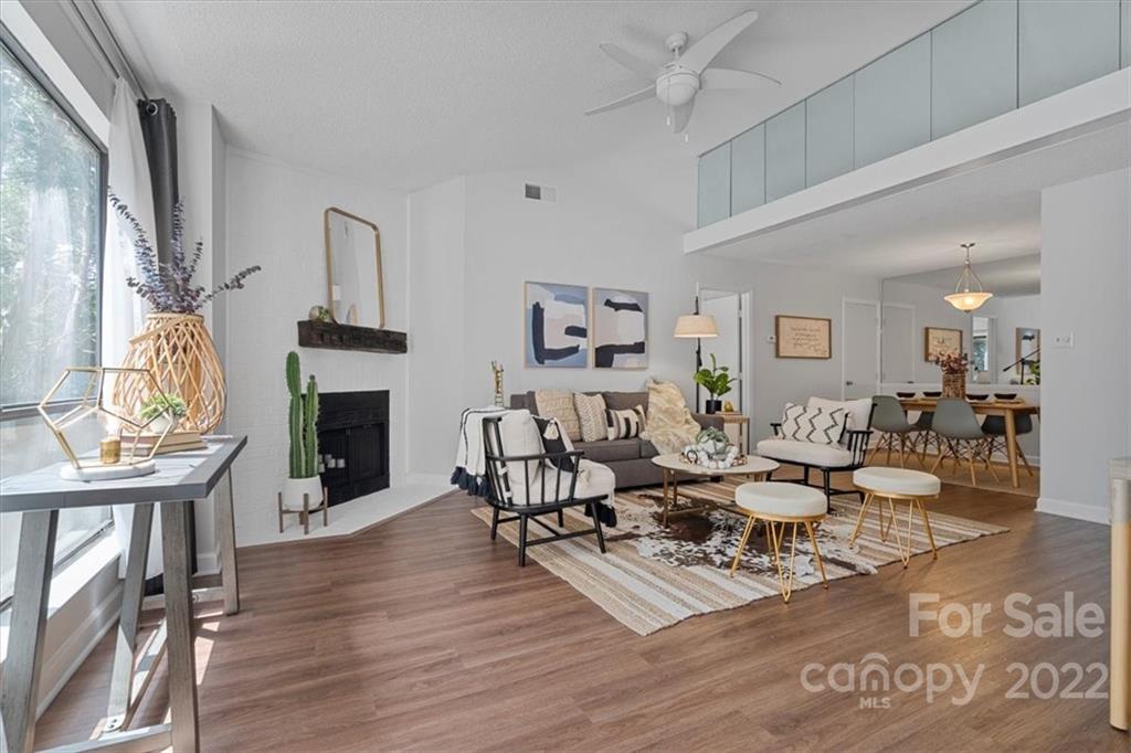 1606 Sharon Road West Charlotte, NC 28210 - Photo 2 of 19 a living room with fireplace furniture and a wooden floor